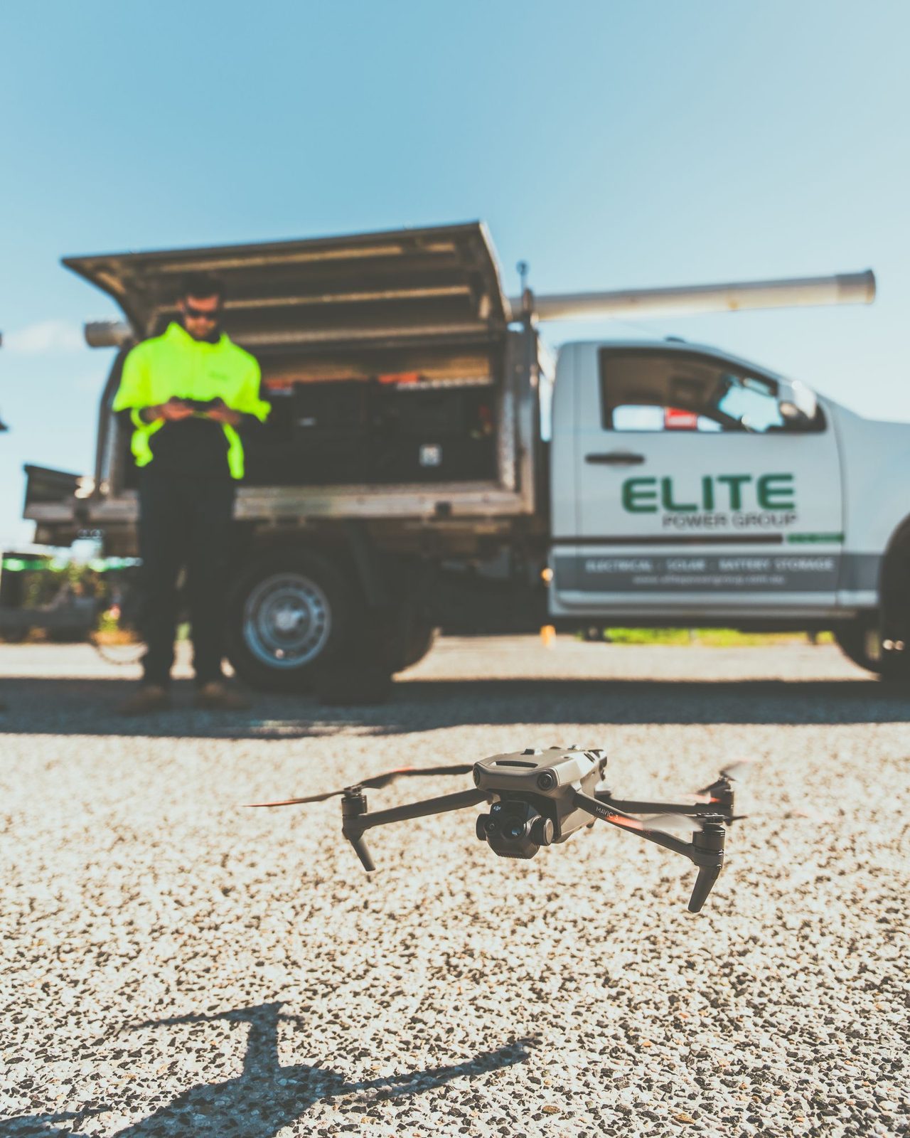 Drone operator preparing an inspection flight at a power transmission site