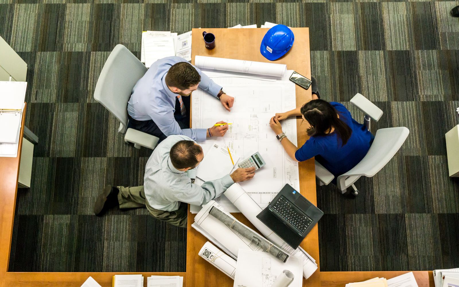 Government project review meeting, evaluators reviewing drone bid documents